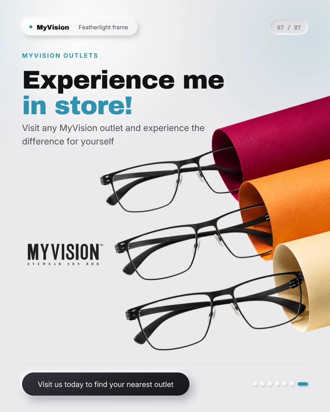 Three slim black metal frames fanned out across rolls of crimson, orange and cream paper beside the My Vision wordmark.